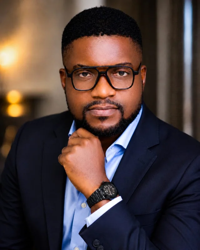 Ikemefuna Egbosimba in a navy suit and glasses